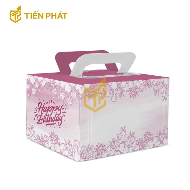 Hộp bánh kem vuông màu hông, in hình hoa và chữ "Happy Birthday"